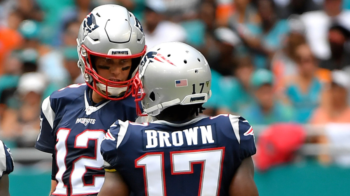 New England Patriots quarterback Tom Brady talks with New wide receiver Antonio Brown near the line of scrimmage against the Miami Dolphins during the first half at Hard Rock Stadium.
